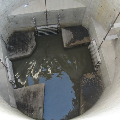 Looking down, you see three sluice gates form Whipps, Inc. preventing flow.