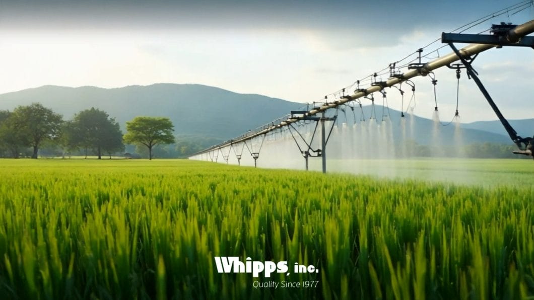 Picture of an irrigation system in action as it waters the crops is was designed to service. The Whipps logo is located at the bottom.