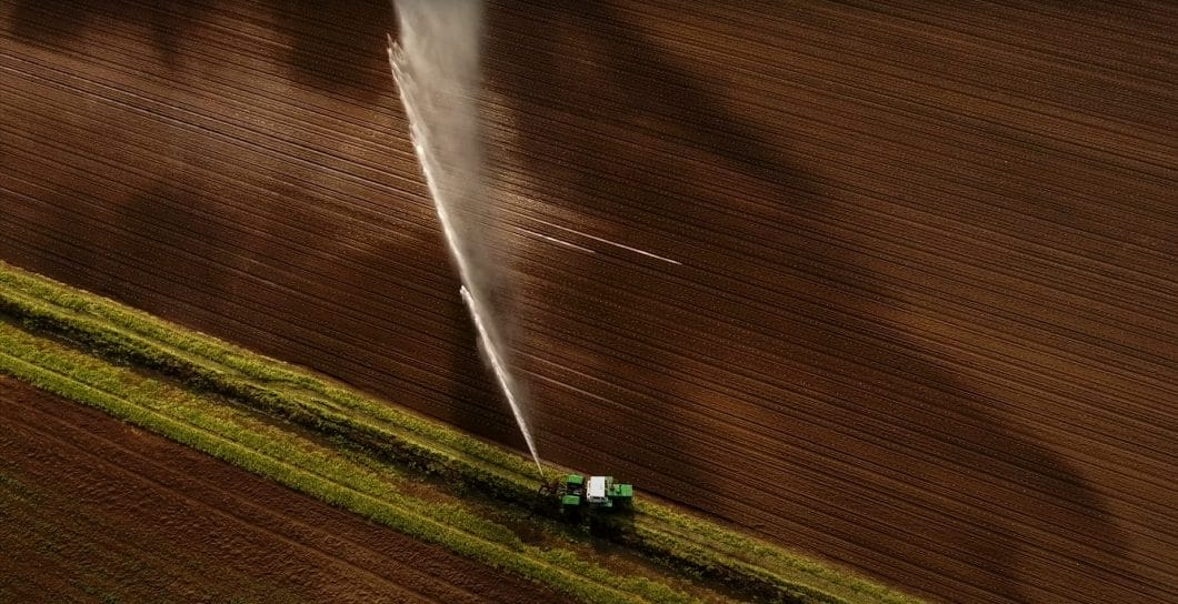A drone shot of crops being watered