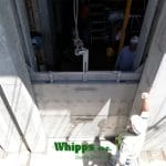 Photo of stainless steel stop logs being installed by a lifter from Whipps, Inc.