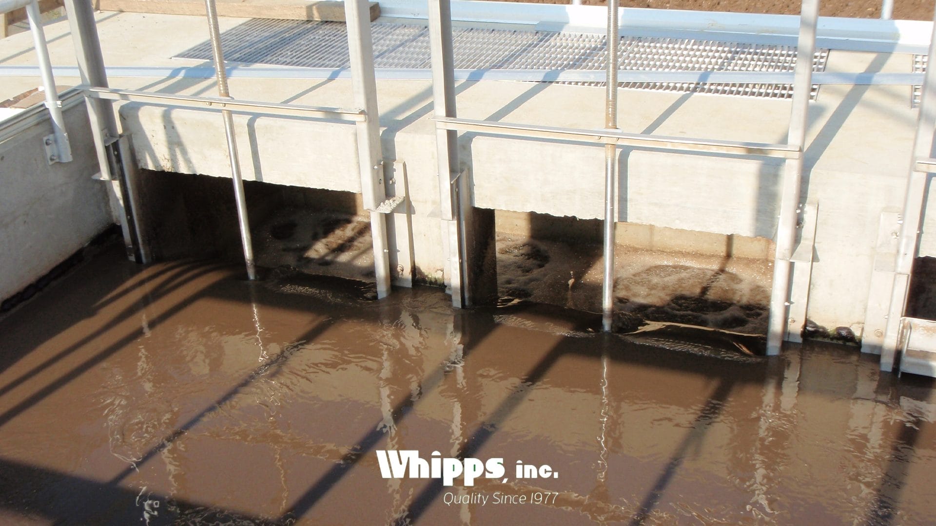 Multiple Whipps, Inc. slide gates operate simultaneously to manage flow in a high-solids wastewater treatment channel.